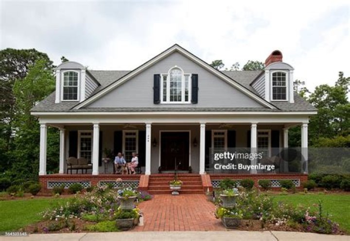 Billy Carson Bond and his wife Evelyn sitting on the porch with their