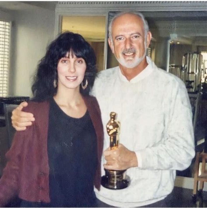 Cher with her adoptive Father, Gilbert LaPiere, holding her Oscar in